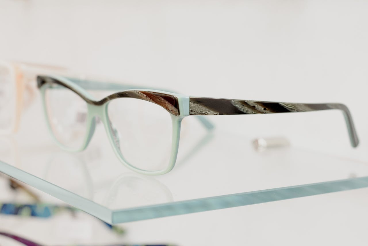 extra-programs-img Modern glasses on transparent shelf in optical shop with various lenses and rims
